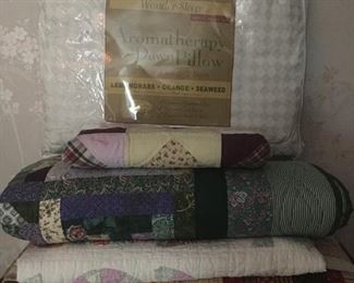 assortment of quilts and aromatherapy pillow