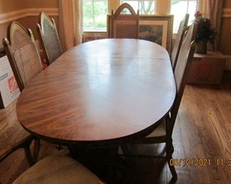 DINING TABLE WITHOUT THE TABLE CLOTH. THIS TABLE HAS A NICE TRESTLE STYLE LEG ON IT. 