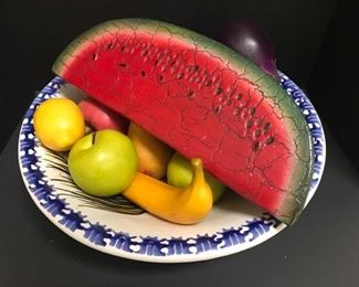 This is a bowl filled with a variety of faux fruit. https://ctbids.com/#!/description/share/949886