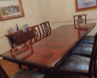 Chippendale Style by Thomasville. Swirl Crotch Mahogany in exquisite condition. 8 chairs, 1 leaf and includes pads