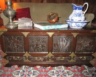 carved wooden chest with brass trim