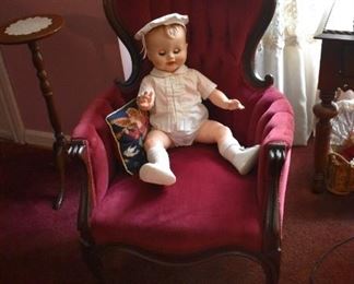 A gorgeous Victorian Chair with Candle Stand behind. Relaxing in this Chair is a very Collectible Boy Doll complete with matching Beret, Clothing and topped off with Sox and Shoes!
