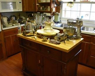 Kitchen Island has many Vintage and Collectible Kitchen Items Atop 