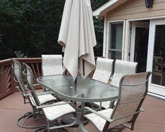 Outdoor patio set with chairs and umbrella