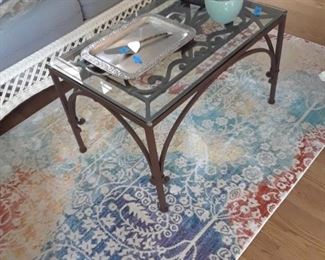 Wrought iron and glass table; accent rug