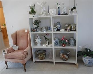 velvet wing-back chair.  Assorted jardiniers, vintage porcelain, and silk flower arrangements.