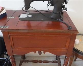 National Sewing Machine with cabinet and original operators manual.