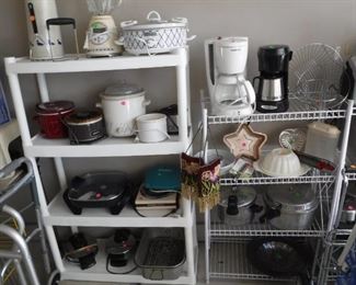Crock pots, coffee makers, blender, pressure cookers, and other assorted kitchen ware.