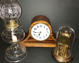 Mantel clock and anniversary clocks, both with gold detailing and a kerosene lantern with gold detailing. https://ctbids.com/#!/description/share/953542