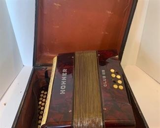 This is a vintage WWII era Hohner Accordion model CLUB III B. Over all it’s in good condition but there are some buttons broken and the case and leather strap are very brittle. The instrument does still play however. https://ctbids.com/#!/description/share/953560