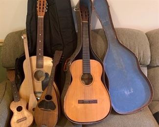 This is a collection of stringed instruments including two guitars, a single string guitar, a mandolin and a ukulele. Guitars come with cases and only one had a label being made by Classic Guitars. https://ctbids.com/#!/description/share/953559