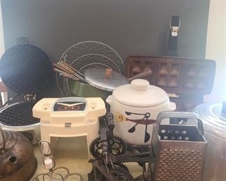 Three glass cutting boards, vegetable chopper, ice bucket. Two fondue pots one is electric with stone bowl and the other is metal with place for flame. Waffle iron, copper tea kettle, wall mounted apple peeler and other useful kitchen tools. https://ctbids.com/#!/description/share/953506