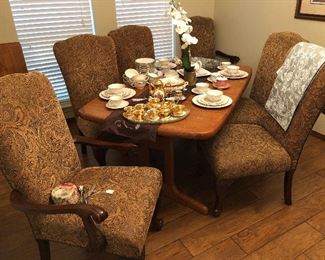 Upholstered, nailhead dining chairs; Modern dining room table with leaves; china sets and decor 