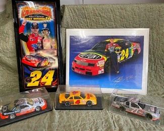 NASCAR
Jeff Gordon clock and poster. Clock hands are a little bent. Poster is in an old frame not in good shape but is protecting the poster. 3 toy cars in plastic display cases.