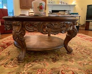 #24	round glass top table with carved sides and legs 40.5x20	 $125.00 
