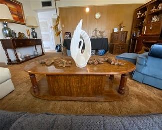 Back view of a beautiful wooden coffee table, with decorative items atop it.