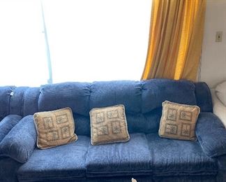 Lovely living room three-cushioned  sofa, with decorative accent pillows. Part of living room furniture set. 