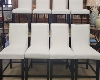 179 - Set of 8 upholstered barstools w/ nailhead trim 41 x 16 x 20 one stool with small black mark on back
