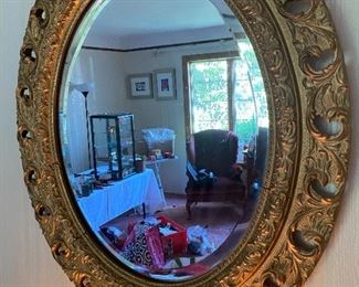 Oval wood & gesso gilt mirror.