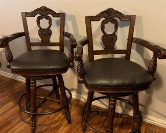 2 carved wood bar stools with leather seats