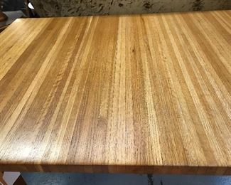 Seller  designed and made this incredible table.  Oak pieces pressed together.  Top comes off and slides and locks in place.  Great Kitchen/work table.