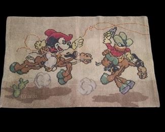 Vintage Walt Disney rug from the early 1940s features Mickey Mouse at the rodeo riding his horse Tanglefoot. Rug has some wear with threads missing. Rug measures 27” x 41”. https://ctbids.com/#!/description/share/955260