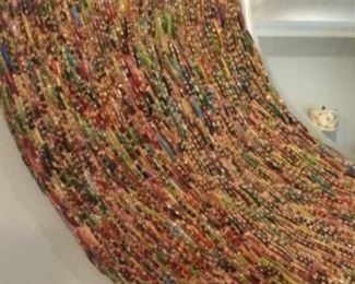 Colorful beaded frame on wall mirror