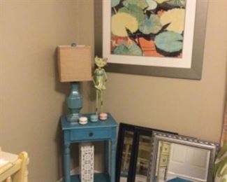 Cute turquoise night stand, lamp, artwork, and mirrors