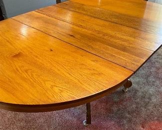 3 leaf oak dining table with four chairs