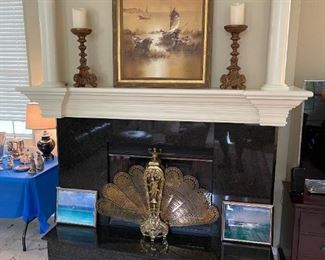 Brass fireplace folding screen, artwork, older Destin photos. 