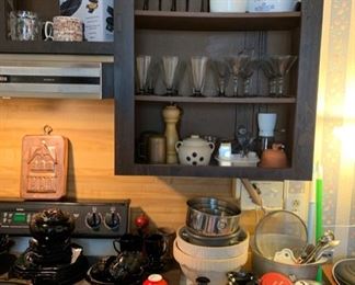 Black stem wine, cocktail and martini glasses, various modern and vintage kitchen tools