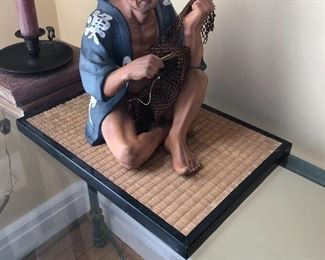 Chinese tradesman figurine on mat