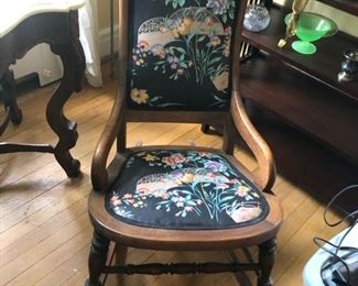 Antique collapsible rocker shown with needlepoint footstool