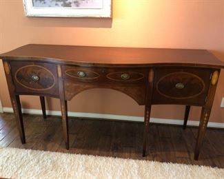 73x36x24 Mahogany Sideboard with beautiful inlay design. Two side cabinets with center pullout drawer for silverware. The square tapered legs have the inlay pattern. Perfect condition and not one scratch. $1200 Delivery can be arranged for a fee