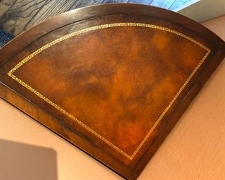 Leather top on the corner table in picture. So beautiful.