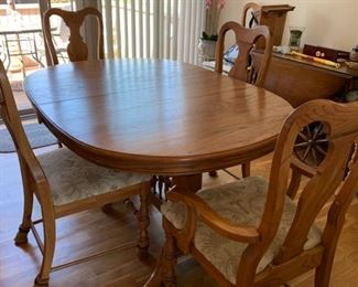 SOLD. 60x42 with two 12" extensions. Table is beautiful and has been covered with felt covered protectors. Table has six chairs, two chairs have arms and four chairs with no arms. $300