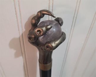 Close up of bronze claw w/clear ball handle cane