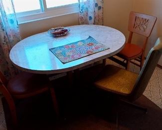 Dinette table with extra leaf available.  Includes gold swival chair if you want it.  4 wooden card table chairs (1 in picture) may be purchased separately.  Placemat and other items on table not included.