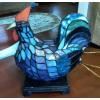 This is a rooster lamp, made of stained glass. It lights up and is in very good condition. See pictures for details