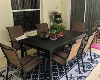 Outdoor table with 6 chairs and outdoor rug