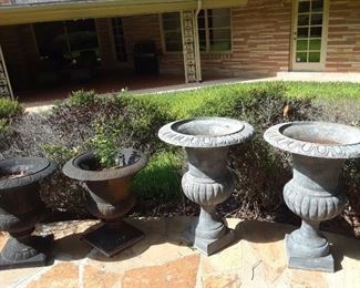 Two pairs of cast iron planters.
