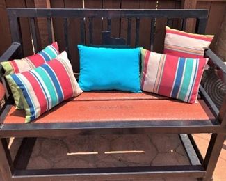 Patio bench and colorful pillows