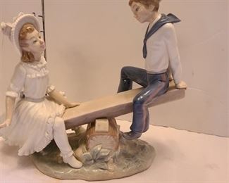 Lladro boy and girl on seesaw