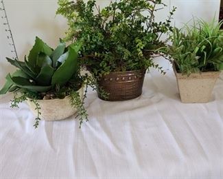 Assorted artificial greenery in pots