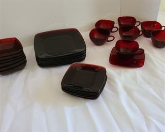 Ruby colored plates, bowls, cups and saucers with a few chips