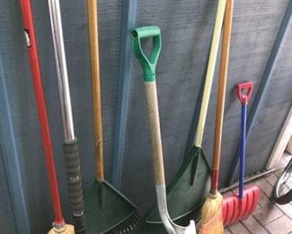 Assortment of Brooms Shovels and Rakes