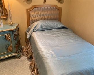 One of two elegant twin bedding sets and headboards
