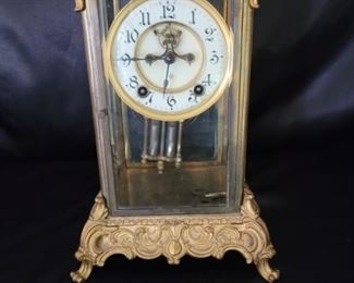 Antique Ansonia "Peer" Crystal Regulator Clock.   Circa 1915, made in Brooklyn, New York
Cast base and top in gilt gold, 8 day movement.  Comes with key.  
8 1/2in w at base, 7in w at top, and 12in tall��
