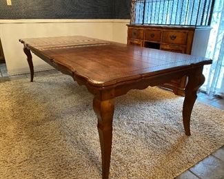 Country French Walnut Dining Table w 2 Leaves.  With scalloped  edges and a panel patterned top, this table elegantly expands with 2 leaves to accommodate all of your dinner guests.