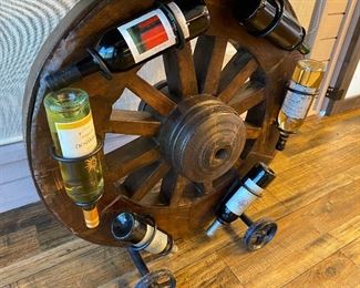 Wagon Wheel Bar Holds 6 Wine Bottles
Looks like the top is the ‘tail gate’ of a stage coach